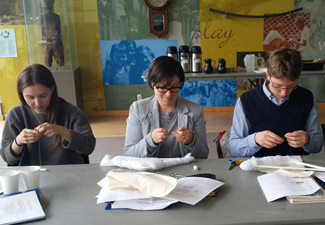 Participants learn how to make padded hangers for textile storage.